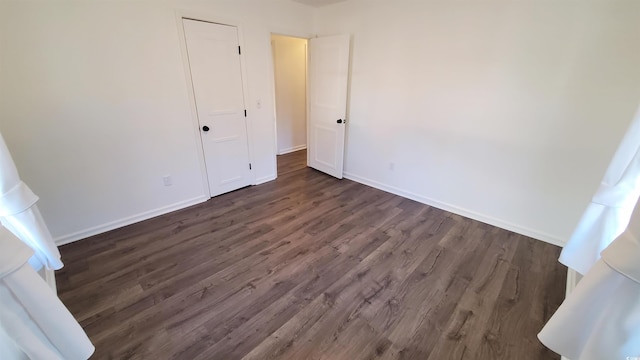 unfurnished bedroom featuring dark wood-type flooring