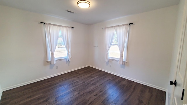 unfurnished room featuring dark hardwood / wood-style flooring