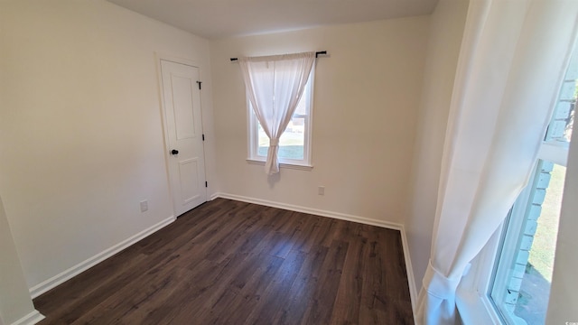 empty room with dark hardwood / wood-style floors