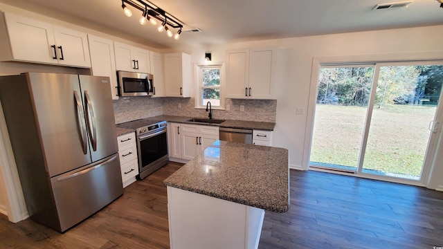 90 Wateree Trl, Georgetown, SC 29440 - kitchen with dark stone countertops, visible vents, decorative backsplash, stainless steel appliances, and a sink