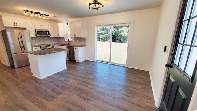 kitchen featuring a center island, dark wood-type flooring, white cabinets, sink, and stainless steel appliances