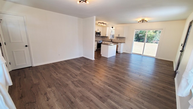 unfurnished living room with dark wood-type flooring