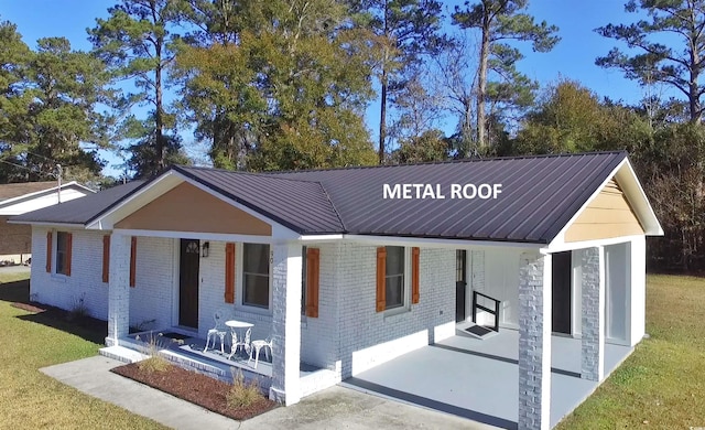 90 Wateree Trl, Georgetown, SC 29440 - view of front of property featuring brick siding, metal roof, and a carport