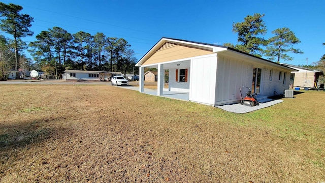 view of side of property with a yard