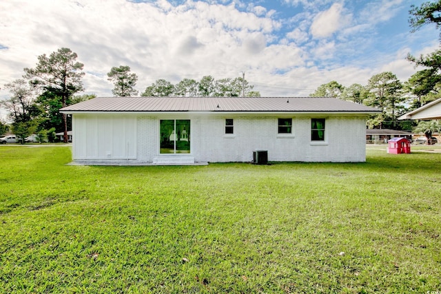 90 Wateree Trl, Georgetown, SC 29440 - back of property with brick siding, metal roof, and a lawn