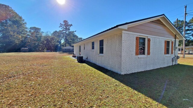 90 Wateree Trl, Georgetown, SC 29440 - view of side of property featuring central air condition unit, a yard, and brick siding