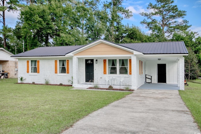 view of front of house with a front lawn and a carport