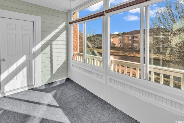 sunroom / solarium featuring a water view