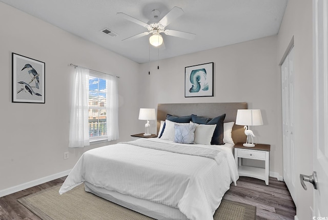 bedroom with ceiling fan, dark hardwood / wood-style flooring, and a closet