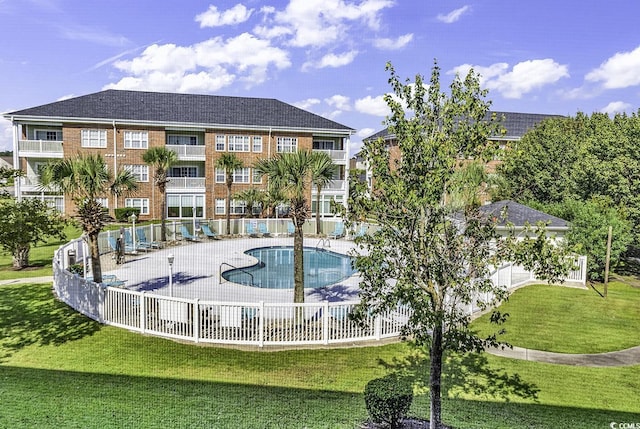 view of pool with a yard and a patio