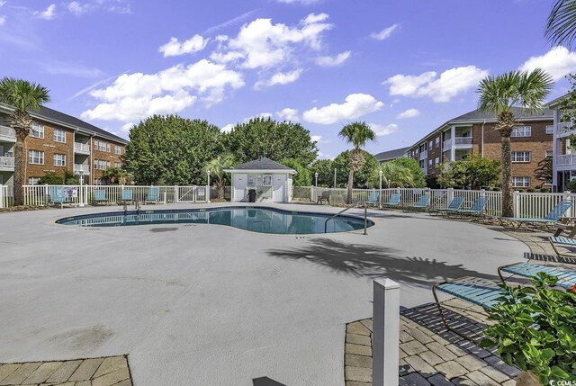 view of swimming pool featuring a patio area