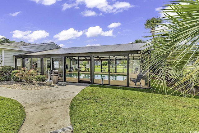 property entrance featuring a pool and a yard