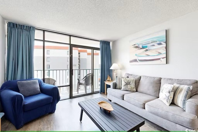 living room featuring floor to ceiling windows and a textured ceiling