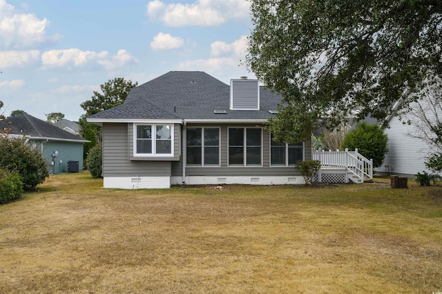 back of property featuring roof with shingles, a yard, a chimney, crawl space, and central AC