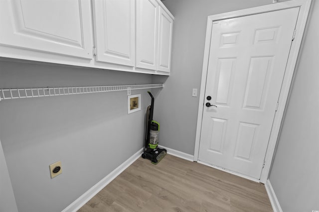 laundry room with hookup for a washing machine, hookup for an electric dryer, baseboards, light wood-style floors, and cabinet space