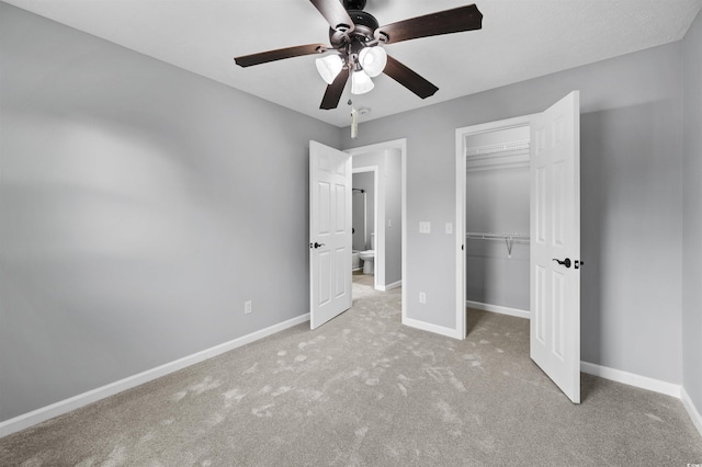 unfurnished bedroom with ceiling fan, a closet, carpet flooring, and baseboards