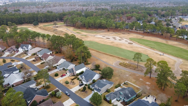 birds eye view of property with golf course view and a residential view