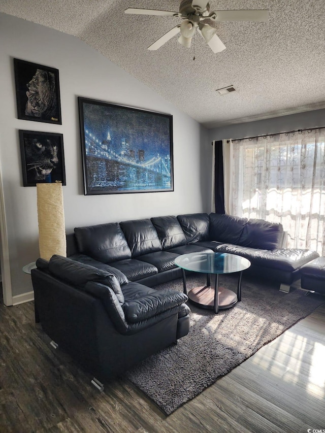 living room with ceiling fan, wood-type flooring, a textured ceiling, and vaulted ceiling