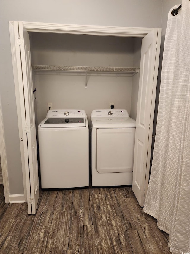 clothes washing area featuring dark hardwood / wood-style flooring and washing machine and dryer