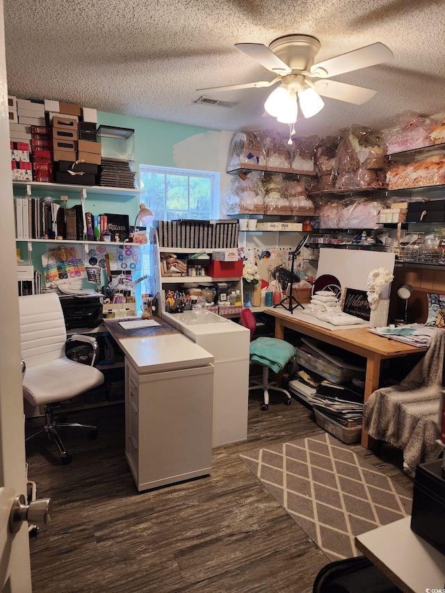 office with ceiling fan, dark wood-type flooring, and a textured ceiling