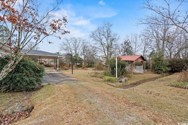 view of yard with driveway and a gazebo