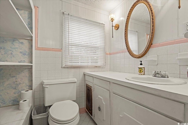 bathroom with toilet, a textured ceiling, and vanity