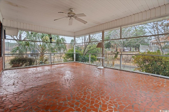 unfurnished sunroom with a ceiling fan