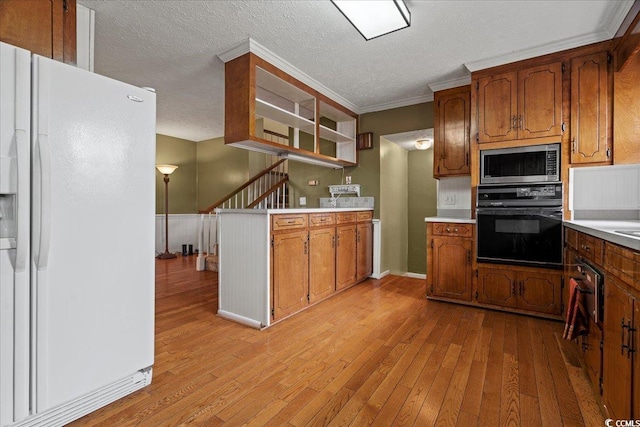 kitchen featuring stainless steel microwave, brown cabinets, oven, light wood-style floors, and white fridge with ice dispenser