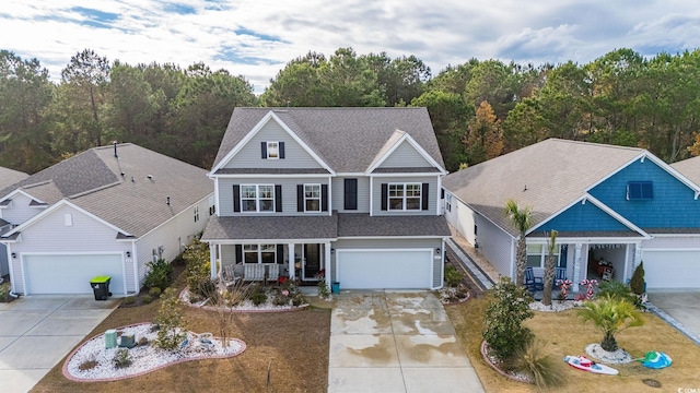 view of front of home featuring a shingled roof, covered porch, driveway, and an attached garage