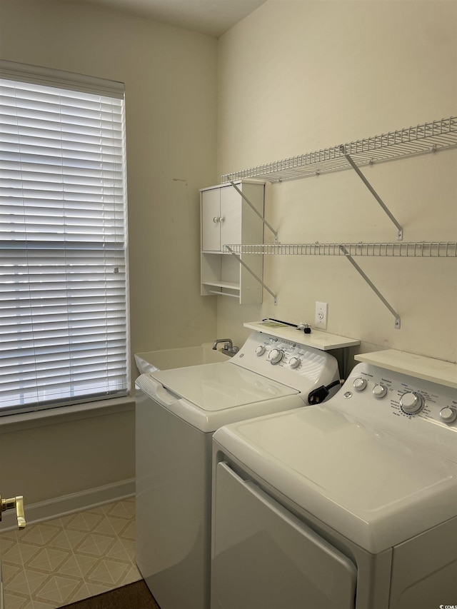 clothes washing area with independent washer and dryer