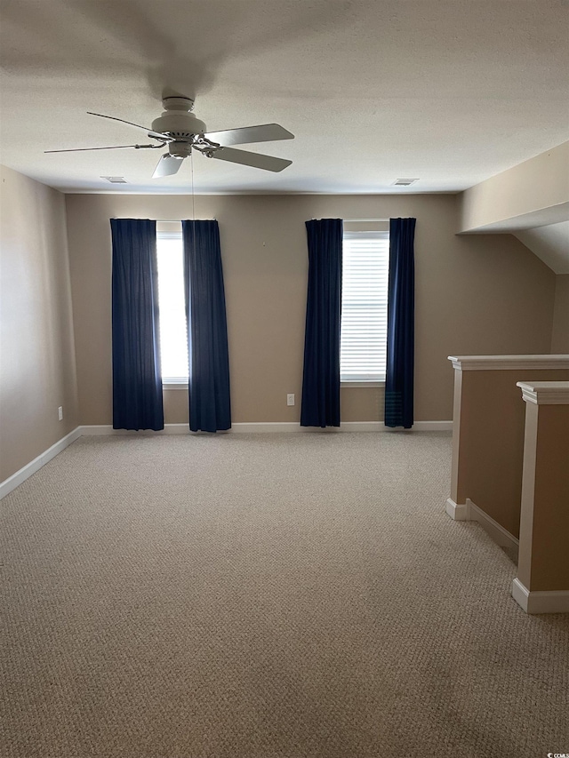 spare room with light carpet and ceiling fan