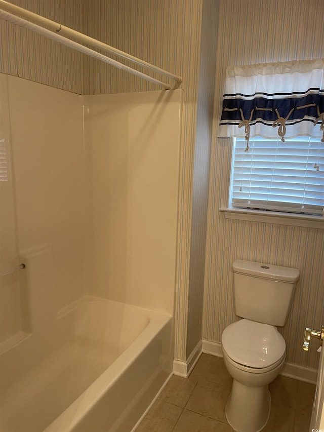 bathroom featuring toilet, bathtub / shower combination, and tile patterned floors