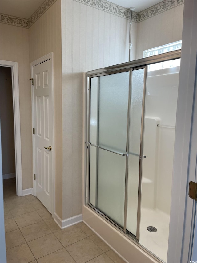 bathroom featuring tile patterned flooring and a shower with door