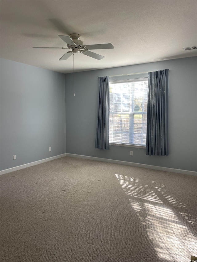 unfurnished room featuring ceiling fan and carpet floors