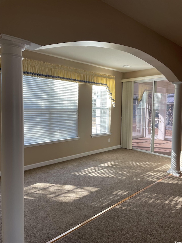 carpeted empty room with ornate columns