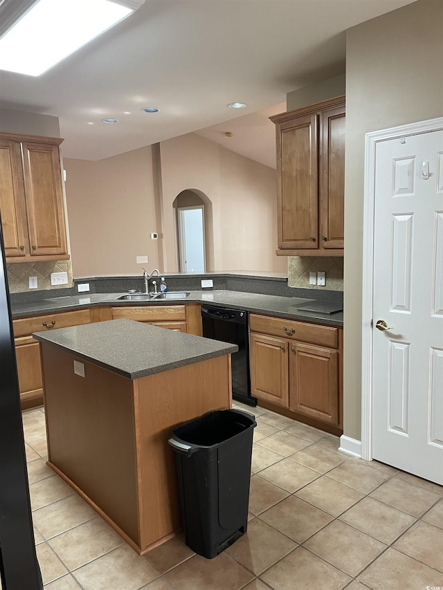 kitchen with kitchen peninsula, sink, light tile patterned floors, dishwasher, and a center island