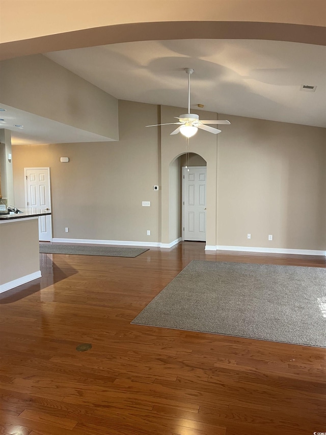 spare room with ceiling fan, dark wood-type flooring, and lofted ceiling