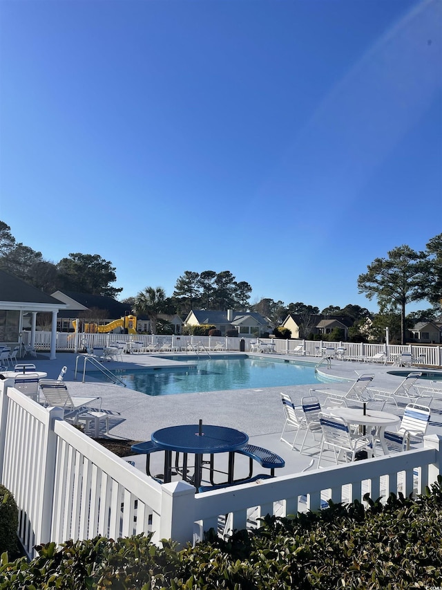 view of swimming pool featuring a patio area