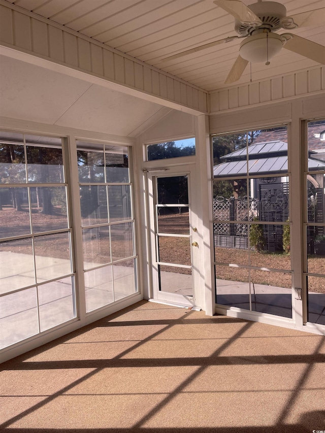 unfurnished sunroom with ceiling fan