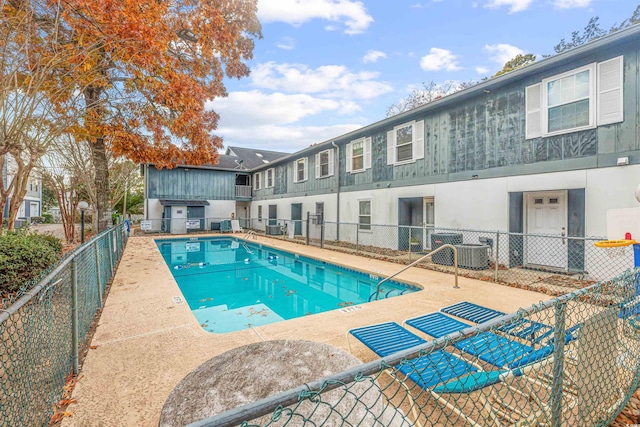 view of swimming pool with central AC unit