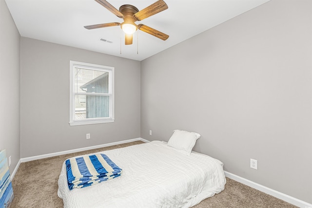 bedroom with ceiling fan, light carpet, and a closet