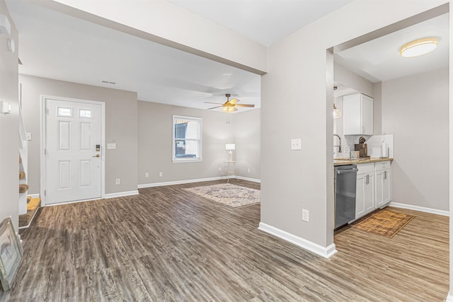 kitchen featuring white cabinets, sink, appliances with stainless steel finishes, tasteful backsplash, and light stone counters