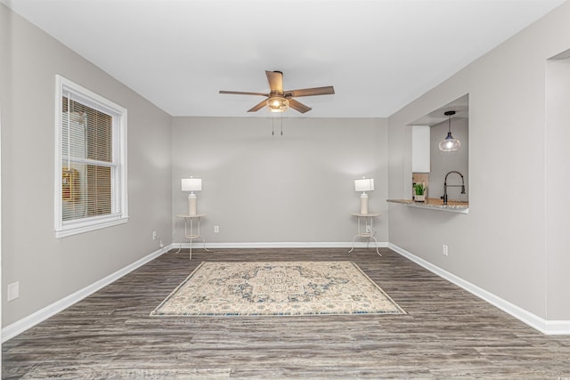 spare room with ceiling fan and dark wood-type flooring