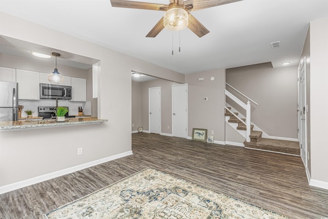 unfurnished room with ceiling fan, dark hardwood / wood-style floors, and sink