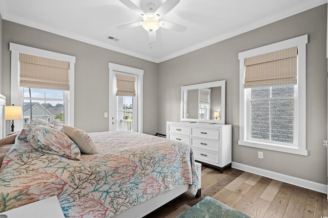 bedroom with multiple windows, ceiling fan, dark hardwood / wood-style floors, and ornamental molding