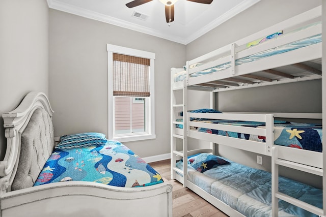 bedroom featuring hardwood / wood-style flooring, ceiling fan, and ornamental molding