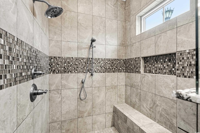 bathroom with a tile shower