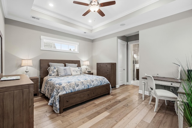 bedroom featuring light hardwood / wood-style floors, a raised ceiling, ceiling fan, and crown molding