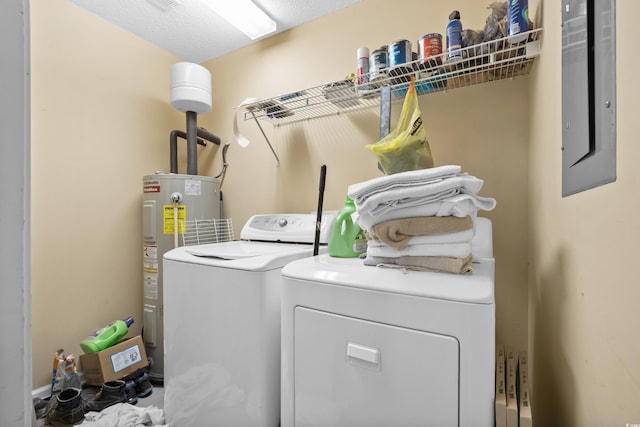 washroom with laundry area, electric panel, separate washer and dryer, and water heater