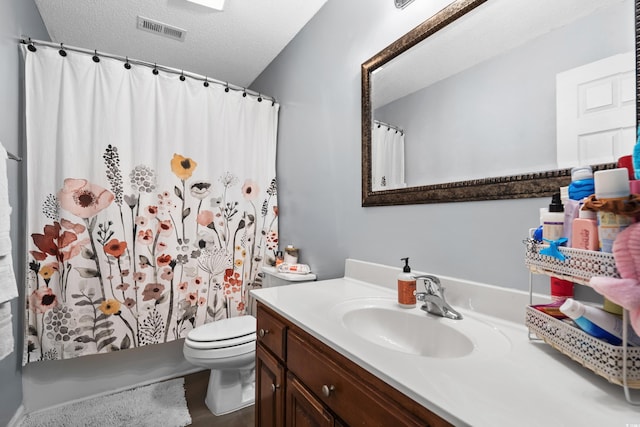 full bathroom with visible vents, a textured ceiling, toilet, and vanity